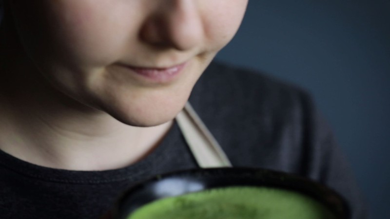 une femme qui boit du matcha dans un bol